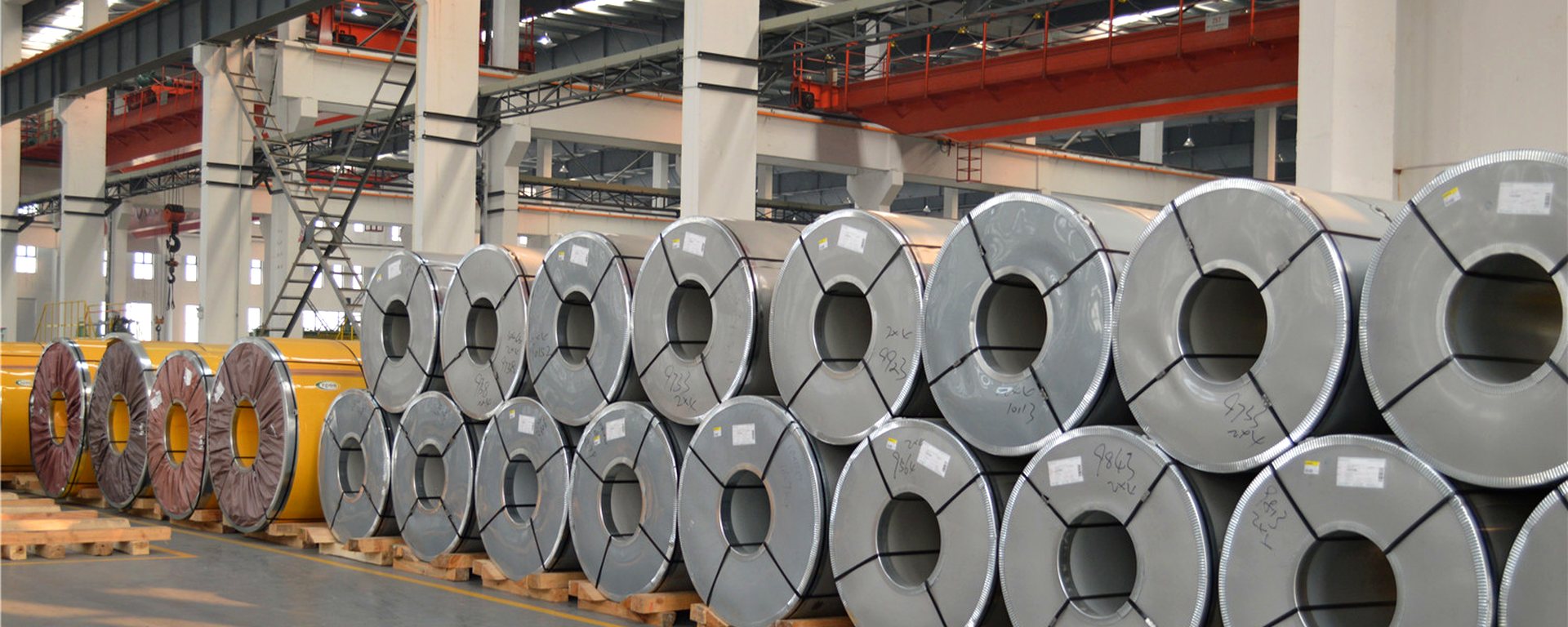 Stainless steel coils on timber skids in the Baowang Steel warehouse, Wuxi, China